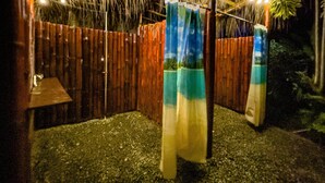 A wooden fence with a thatched roof and string lights. - Latitude Adjustment, Heart of Manuel Antonio, 1BD (Quepos)