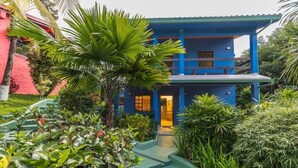 A two-story building with a blue exterior and a central entrance. - Latitude Adjustment, Heart of Manuel Antonio, 1BD (Quepos)