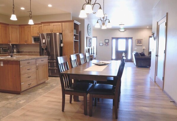 Enjoy cooking in this well-equipped kitchen with a central island, dining table, and modern appliances.