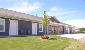 Stunning two-story building with a covered porch and beautifully landscaped front yard.