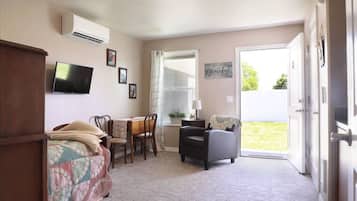 Relax in this inviting space with a flat-screen TV, dining table, and comfortable armchair.