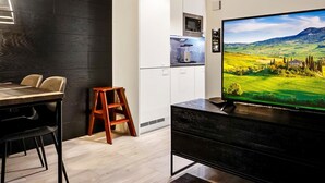 A modern kitchen with white cabinets and a built-in microwave.