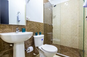 A bathroom with a sink, toilet, and shower.