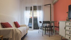 Een slaapkamer met een bed, een bureau, een stoel en een kledingkast.