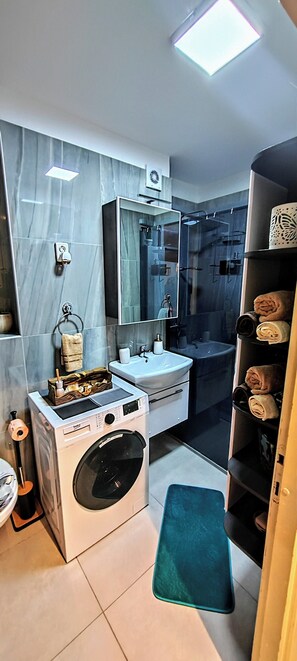 Shower, hair dryer, towels, shampoo