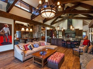 Relax in this stylish space with a comfortable seating area, kitchen, and bar.