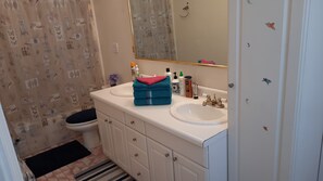 Combined shower/tub, hair dryer, towels, soap