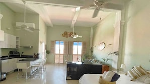 A spacious living area with a kitchen, dining area, and a large bed. - Tropicalia is a Charming Studio in the middle of the Old City of Cartagena. (Cartagena)