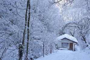 A snow-covered cabin surrounded by trees. - House By The Stream in Soča Valley, Kanal ob Soči, Slovenia (Kanal ob Soči)