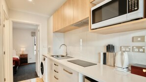 A compact kitchen with a microwave, sink, and a coffee maker. - Star View - 1 Bedroom suite C (Lake Tekapo)