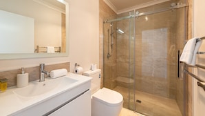 A modern bathroom with a glass-enclosed shower, a white sink with a mirror above, and a toilet. - Star View - 1 Bedroom suite C (Lake Tekapo)