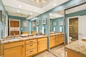 A bathroom with a large mirror, wooden cabinets, a sink, and a shower area. - Aston Maui Kaanapali Villas 262 | Tropical Garden Views – Pool, Hot Tub & Spa (Lahaina)