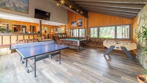 A spacious indoor recreational area with a ping pong table, foosball table, and pool table. - Walk to Ski, Near Canyon Lodge, Quiet Getaway 512 (Mammoth Lakes)