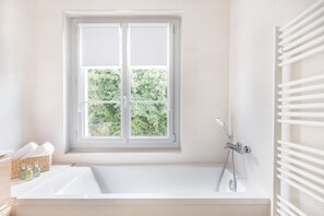 A modern bathroom with a large window, a bathtub, and a shower. - Maison Avec vue sur le Lac, Plage 200m (Bilieu)