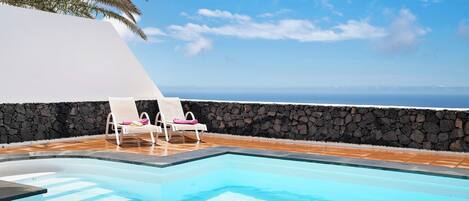 A heated pool, sun loungers