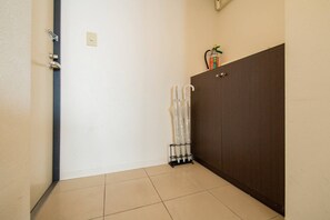 A hallway with a door, a radiator, and a cabinet. - Blue (Sapporo)