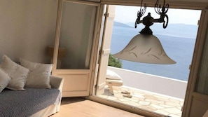 Enjoy breathtaking views of the sea and surrounding mountains from this room's large window.
