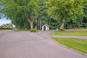 Stroll down this charming residential street lined with lush greenery and tall trees.