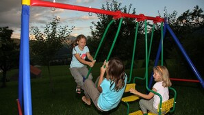 A playground with swings and a slide.