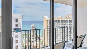 A balcony with a view of the ocean and buildings. - Waikiki Banyan Condo With Panoramic 37th Floor Ocean Views (Honolulu)