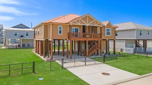 A two-story house with a balcony and a covered porch. - Copper Top | Moments from Beach (Galveston)