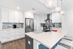 Fridge, dishwasher, coffee/tea maker, cookware/dishes/utensils