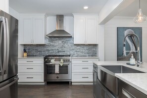 Fridge, dishwasher, coffee/tea maker, cookware/dishes/utensils