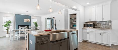 Fridge, dishwasher, coffee/tea maker, cookware/dishes/utensils