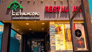 The exterior of the Lebanese restaurant with a signboard and a menu poster. - Hotel Lebanon INN (Tirupporur)