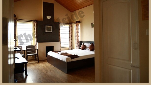 A bedroom with a bed, a desk, and a chair. - The Hill Side (Ootacamund)
