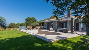 A modern house with a patio, outdoor seating, and a swimming pool. - AVITHOS BLUE VILLA  (kefalonia)