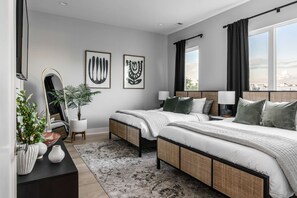 A modern hotel room with two beds, a large mirror, and artwork on the walls. - Casa Paradisa • Rooftop, Fire Pit, Skyline Views (Nashville)