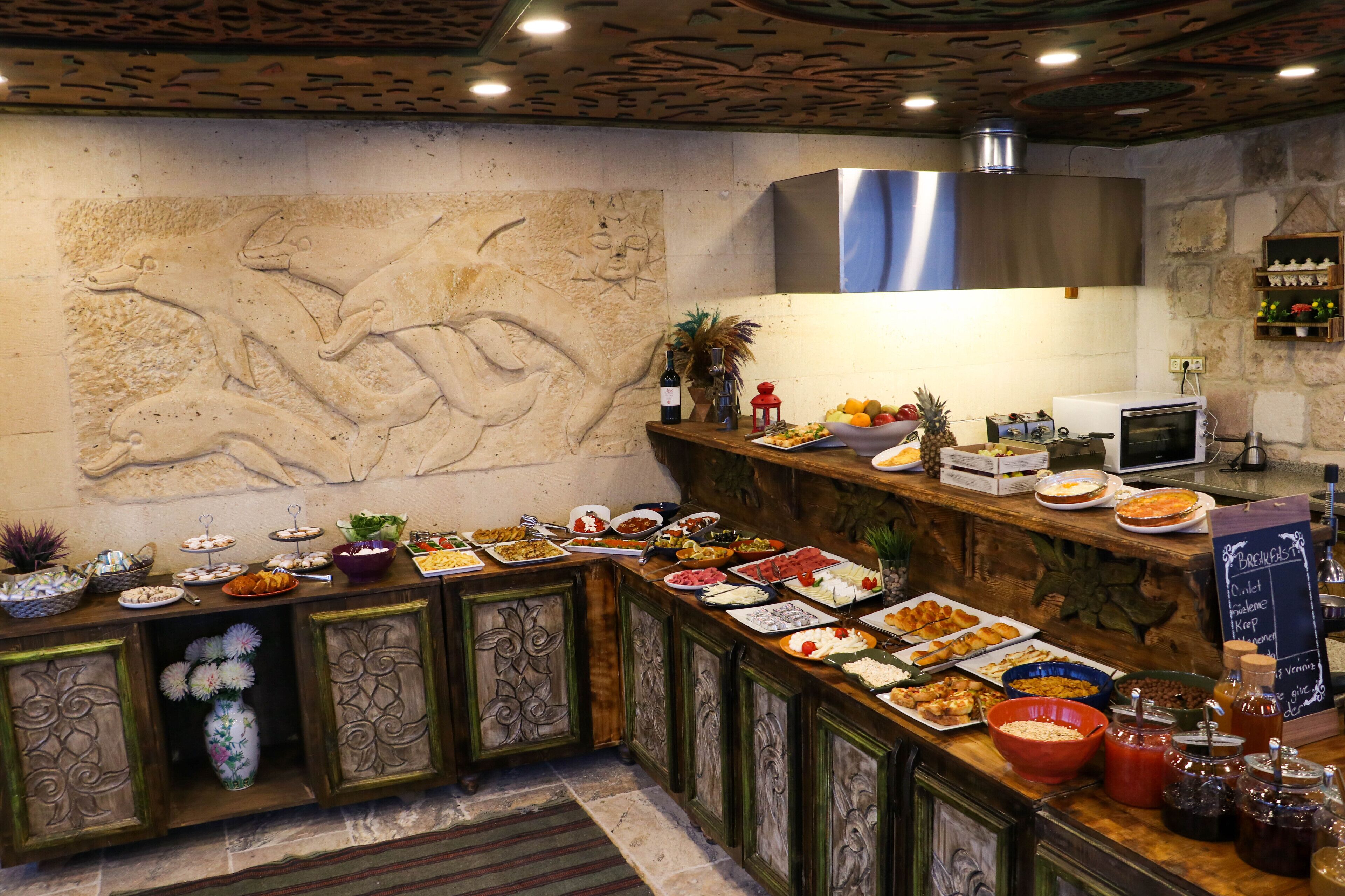 A buffet setup with various food items and a chalkboard menu.