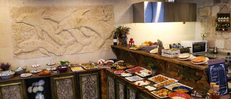 A buffet setup with various food items and a chalkboard menu.