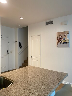 Enjoy cooking in this well-equipped kitchen with a granite countertop and stainless steel sink.