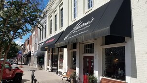 A row of buildings with storefronts, including a restaurant named "Moulin."