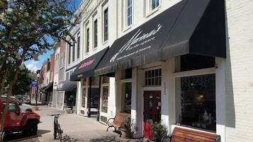 A row of buildings with storefronts, including a restaurant named "Moulin."