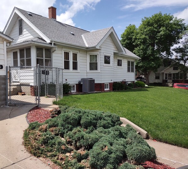 A two-story house with a fenced yard and a well-maintained lawn.