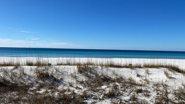 A beach with white sand and clear blue water under a clear sky. - Fabulous 1BR Condo with amazing beach views sleeps 4. Park by door. Pool. (Panama City Beach)