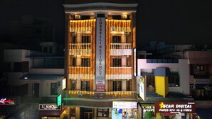 A hotel with a prominent 'CORBELLISENIY' sign, multiple balconies, and a 'STAR DIGITAL' sign indicating photo, studio, and video services. - Corbelli Residency  (Puducherry)