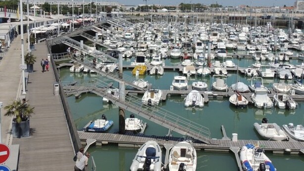 A marina with numerous boats docked in calm waters, a pedestrian walkway, and a clear sky. - 2-Bedroom Apartment in City Center with Terrace and Private Parking in Royan (Royan)