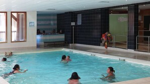 An indoor swimming pool with multiple lanes, tiled walls, and a reception area. - Les Orres 1800: 3-room Apt, Pool, WiFi, Pets allowed (Les Orres)