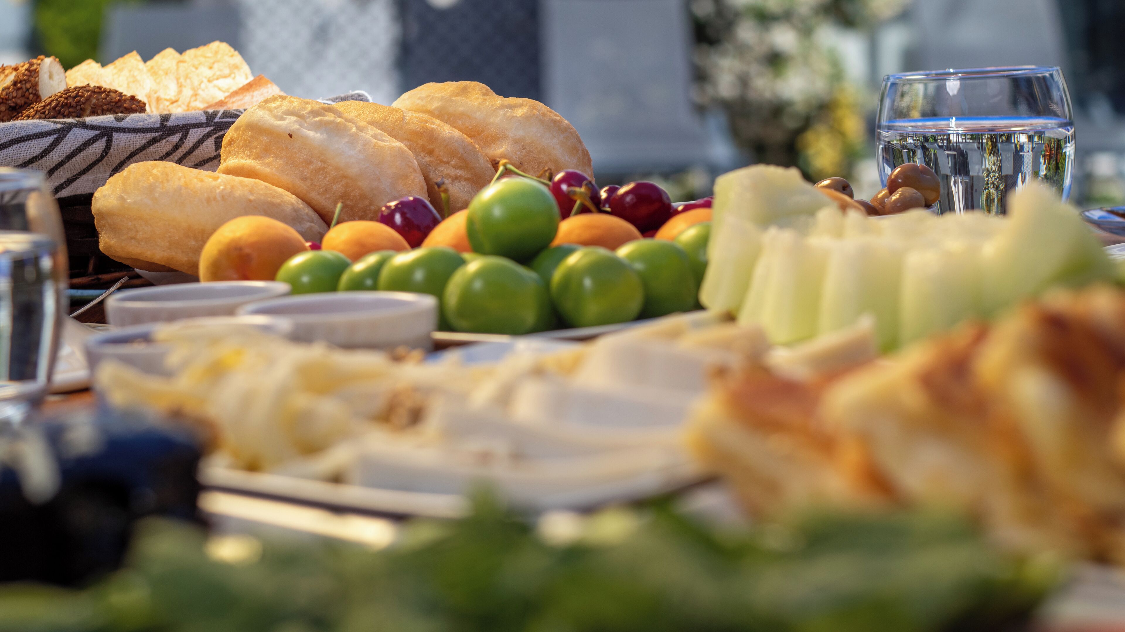 A table with various food items including bread, cheese, and fruits.
