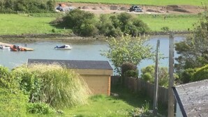 A rural landscape with a river, boats, and grazing sheep. - Croak Cottage, backing on to Frogmore Creek, part of the Salcombe Estuary (Frogmore, Kingsbridge)
