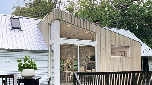 A modern two-story house with a deck, large windows, and a potted plant. - Contemporary Cottage less than an hour from NYC! (Highland Lakes)