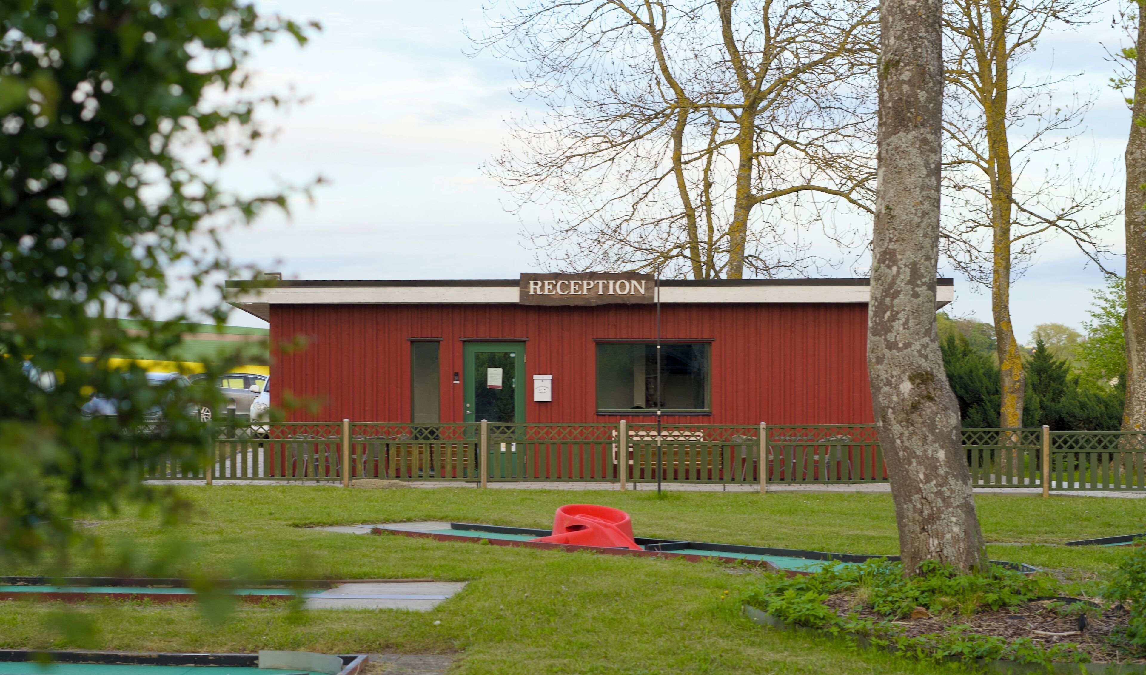 A red building with a sign reading "RECEPTION" at the entrance.