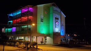 A multi-story hotel with a sign reading "Ocean Suite Club."