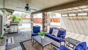 A covered patio area with a grill, seating, and a pool. - Private HEATED POOL at the Wine Time Villa! (Lake Havasu City)