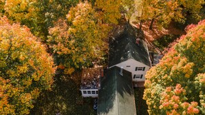 An aerial view of a house surrounded by autumn foliage. - Lovely spacious 6 BR home in St. Croix River valley (Taylors Falls)