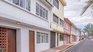 A row of residential buildings with a narrow street.